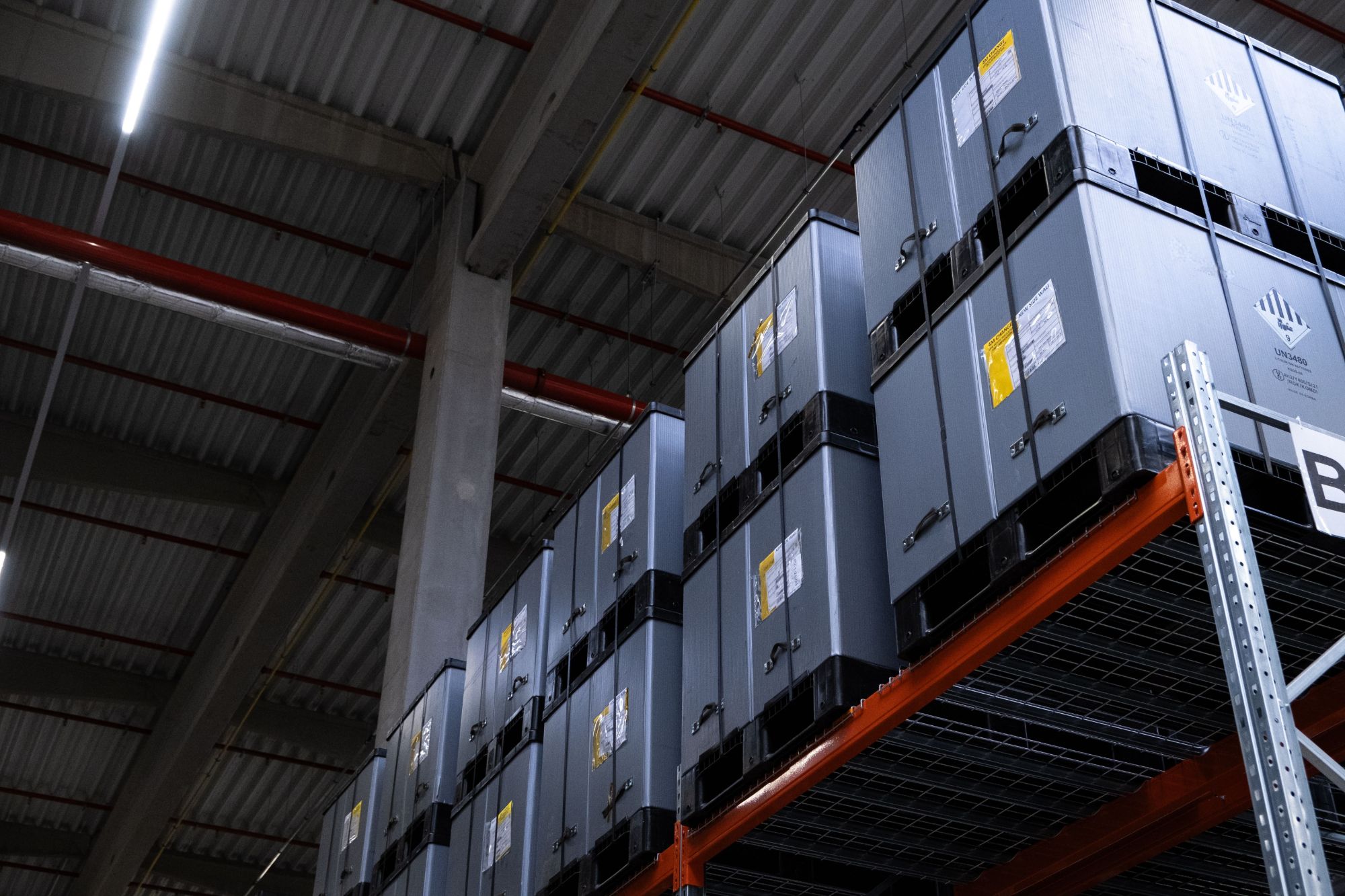 Grey storage containers stacked in a CHB warehouse