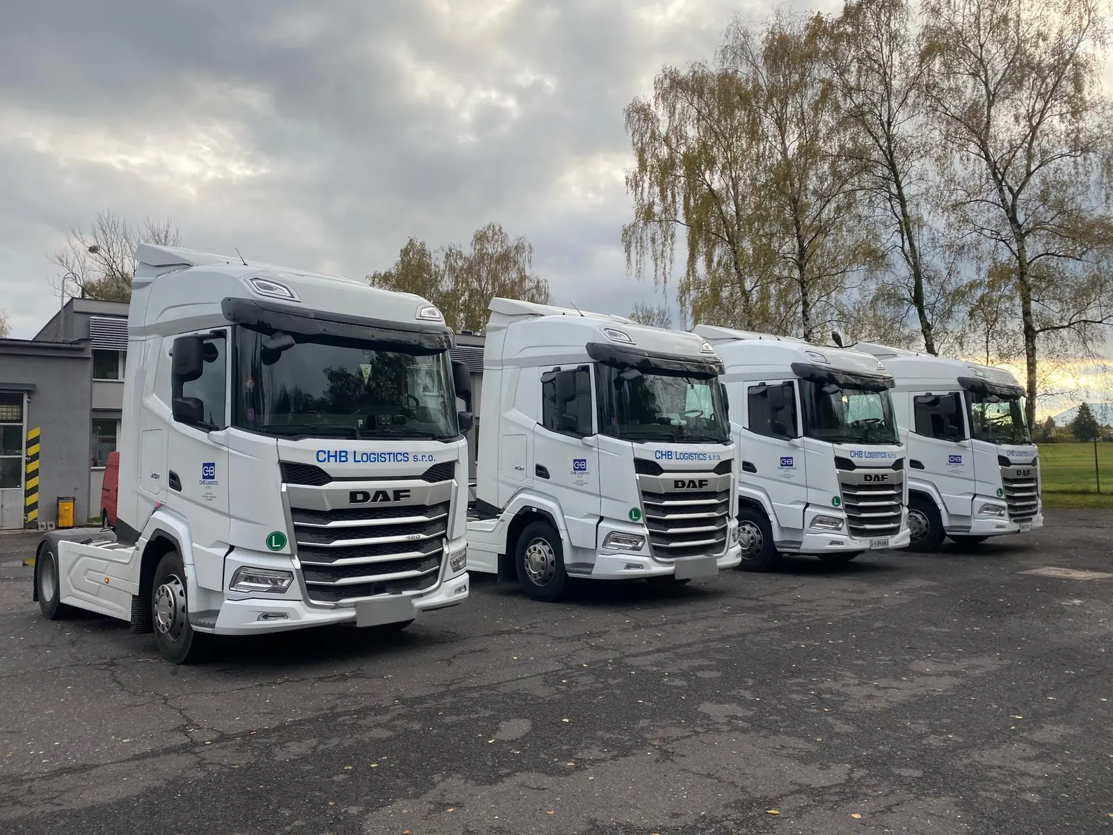 Four CHB Logistics DAF trucks parked in a row